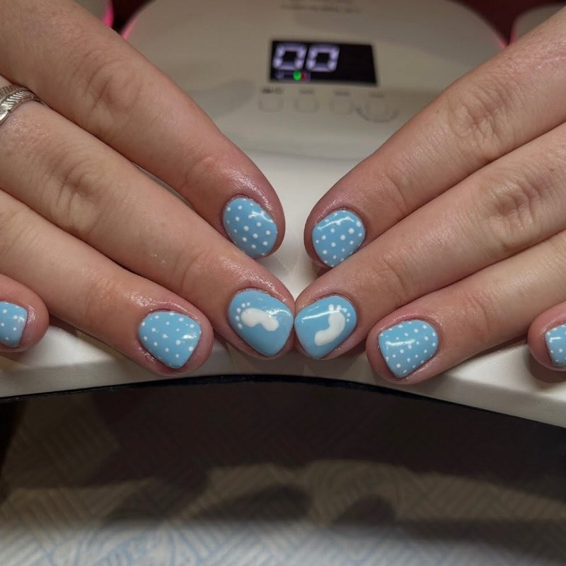 Baby blue gel nails with white clouds and dots