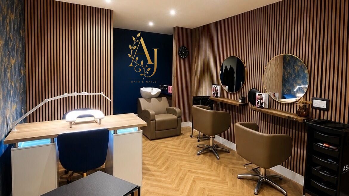 Inside AJ Hair & Nails: navy wall, slatted oak panelling, gold mirrors and the nail desk